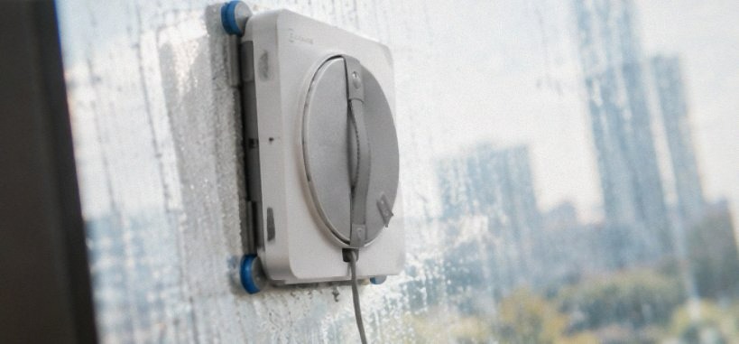 ECOVACS WINBOT W2S Omni window cleaning robot docked in its 6-in-1 multifunction station